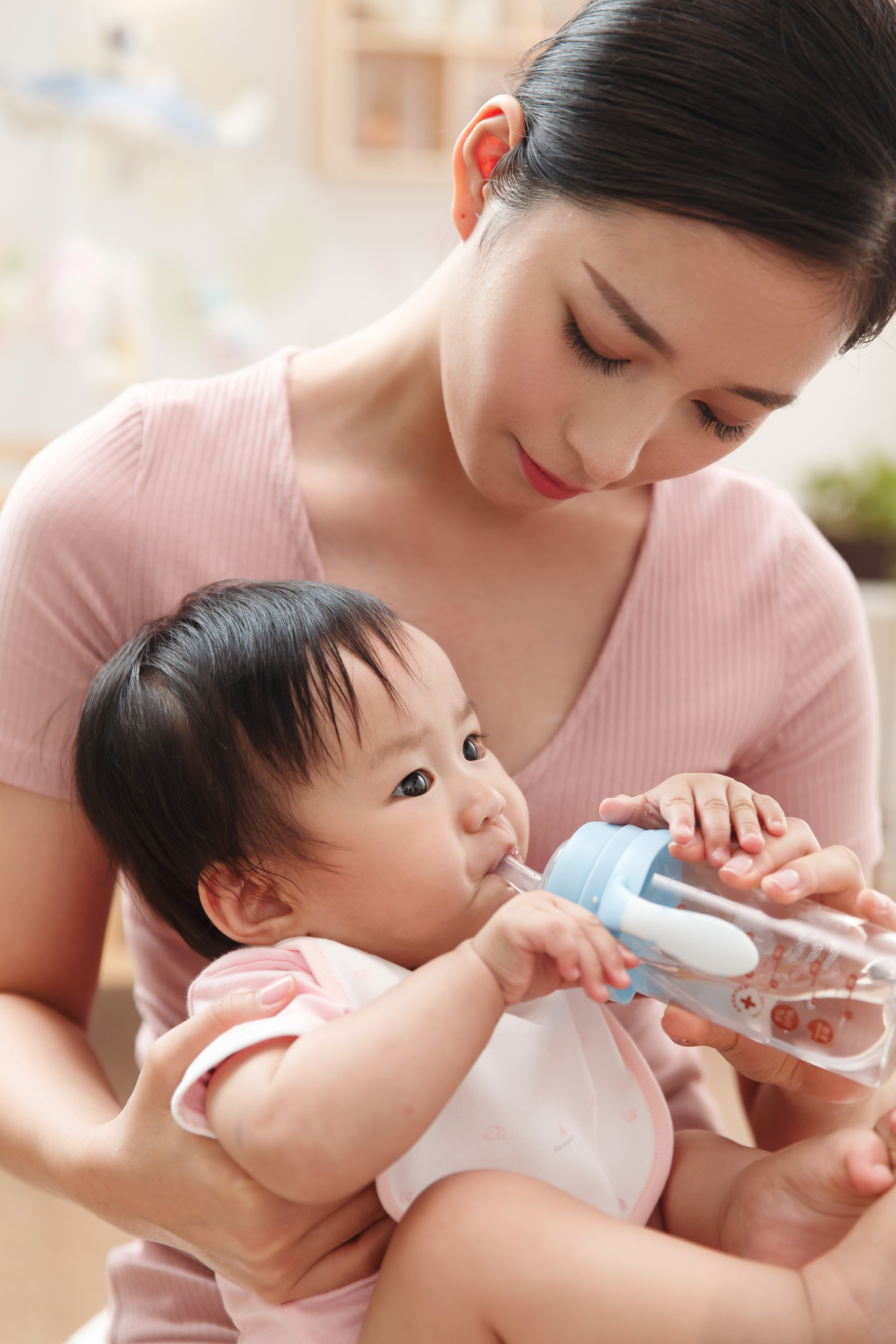 Mother feeding the baby to drink
